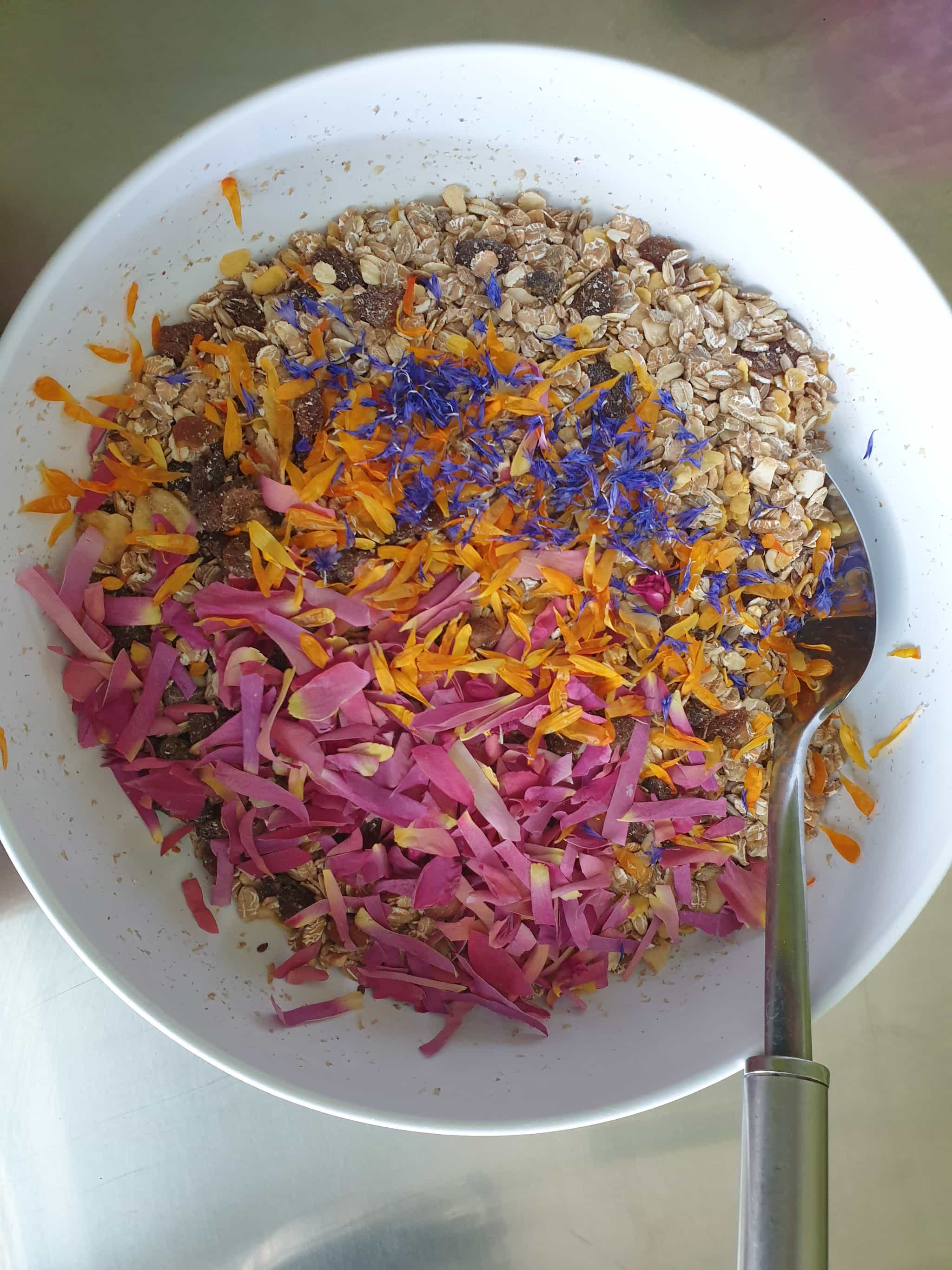 Flower granola | Delicious german muesli style morning breakfast with a special twist: not only fruits, nuts and chocochips but 3 types of homegrown organic medicinal flowers are added as well: roses, calendula and cornflowers