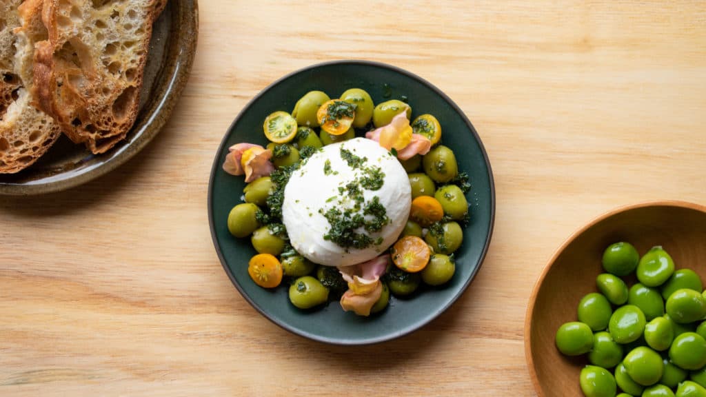 MASTODON PEAS WITH BURRATA AND WILD HERB OIL